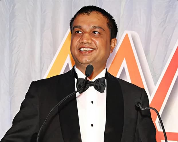 Arun Panchariya speaking at a podium